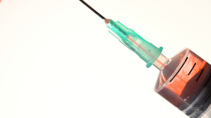Syringe close up taking mixing blood of a patient with drug and injection. Saline solution mixing with liquid blood. Medical procedure and administration of supervised opioid treatment.