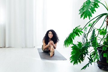 Female brunette engaged in yoga fitness asana body flexibility