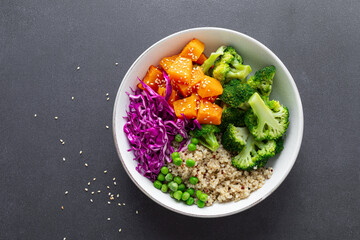 Vegetarian quinoa and broccoli lunch Buddha bowl with baked butternut squash or pumpkin, green peas...