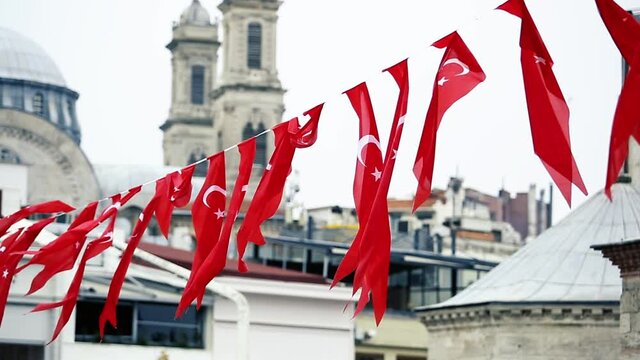 National Turkish red flag with white crescent and half-moon waving on rope in center of the city before presidential ellections of Erdogan in 2018.National symbol of Turkey in close up video clip