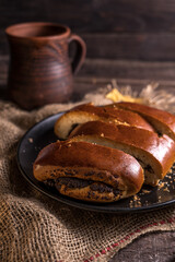 Autumn still life, fresh baked bun on wooden background