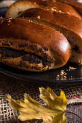 Autumn still life, fresh baked bun on wooden background