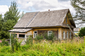 Fototapeta na wymiar Old rural wooden house in abandoned russian village