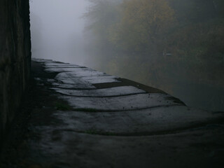Canal path on a foggy misty day landscape