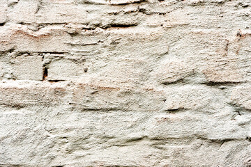Texture of a brick wall with cracks and scratches which can be used as a background