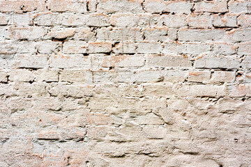 Texture of a brick wall with cracks and scratches which can be used as a background