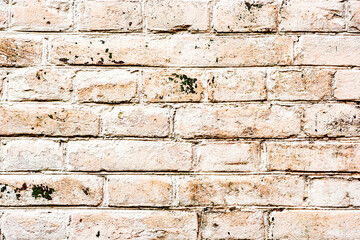 Texture of a brick wall with cracks and scratches which can be used as a background