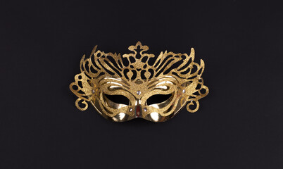 golden masquerade mask isolated on black background - obrazy, fototapety, plakaty
