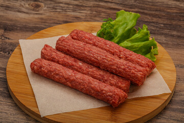Raw beef sausages with spices