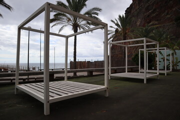 empty daybeds during corona crisis at a deserted bar in Ponta Do Sol, Madeira, Portugal