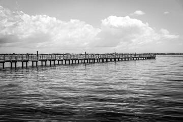 Fototapeta na wymiar The fishing piers on Charlotte Harbor in southwest Florida in black and white.