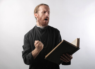 portrait of a young priest while reciting bible verses