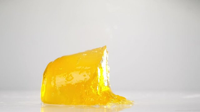 Yellow jelly falling down. Сlose up slow motion.