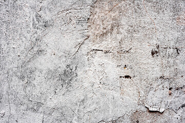 Texture of a concrete wall with cracks and scratches which can be used as a background