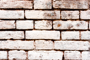 Texture of a brick wall with cracks and scratches which can be used as a background