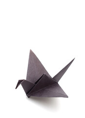 black origami paper crane on white background