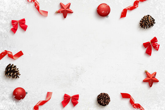 Christmas composition with red decorations on clean surface wirh copy space in the middle. Top view, flat lay