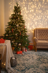 Festive interior with comfortable sofa and decorated Christmas tree