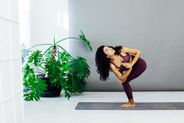 Beautiful brunette woman engaged in yoga sports fitness asana body flexibility