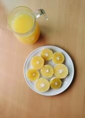 Orange juice and orange slices on wooden table, delicious orange juice for breakfast 