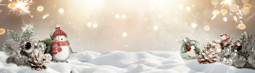 Christmas decoration ornaments  on snow with bokeh background. Snowy christmas background.