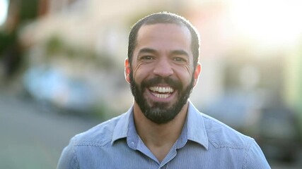Man smiling and laughing outdoors with lens-flare. Person in 40s smile and laugh - Powered by Adobe