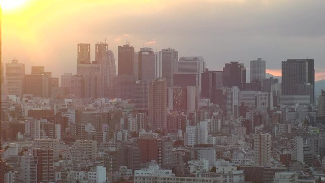 TOKYO, JAPAN : Aerial high angle sunrise or sunset CITYSCAPE of TOKYO. View of office buildings at downtown area Shinjuku. Japanese urban metropolis concept. Real time fixed shot.