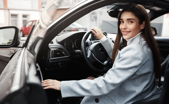 Successful Businesswoman Getting Out Of Car And Smiling. Female Executive Getting In Vehicle To Drive At Work