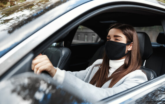 Businesswoman In Car Wearing Face Mask, Going On A Meeting. Woman In Formalwear Driving To Work