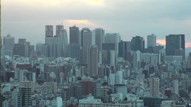 TOKYO, JAPAN : Aerial high angle sunrise CITYSCAPE of TOKYO. View of office buildings at downtown area around Shinjuku. Japanese urban metropolis concept shot. Long time lapse shot night to morning.