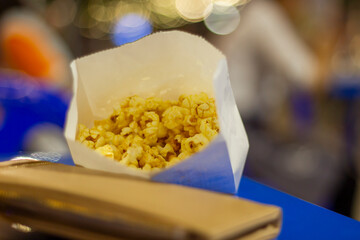 Yummy yellow popcorn in white recycled paper bags to clear dry food.