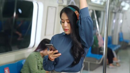 Young woman mobile phone on public train . Urban city lifestyle commuting concept .