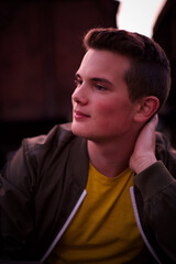 Fototapeta premium A young man sitting on the railways and looking forward.