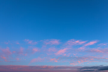 Background of mystery purple and pink clouds on blue sky at evening after sunset. Wide angle photo shot