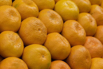 Fresh tangerines stacked at a local market.