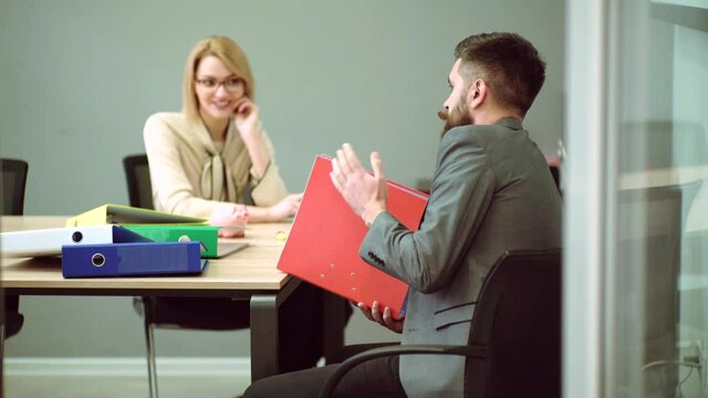 Businessman talking with businesswoman. Secretary and director. Employee in office at workplace. Handsome business man, young boss.