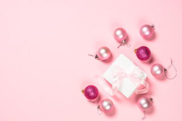 Christmas flat lay background with christmas present and decorations on pink.