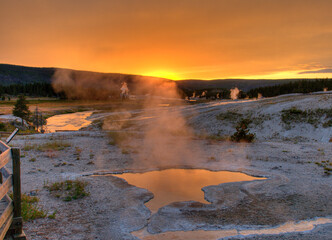 Blue Star Spring At Upper Geyser Basin Yellowstone National Park Shimmering At Sunset On A Sunny Summer Day With A Clear Blue Sky And A Few Clouds