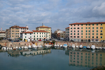 view of the ancient buildings and the canal with boats within the city