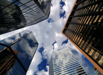 Bottom Up View To The Skycrapers Of The Financial District In Denver Colorado On A Sunny Summer Day With A Clear Blue Sky And A Few Clouds