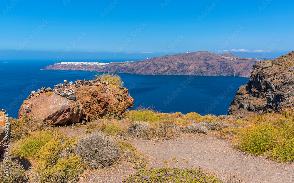 Wall mural a view from skaros rock on santorini towards the northern rim of the caldera in summertime