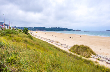 Fototapeta na wymiar Erquy, Cotes-d-Armor, France - 25 August, 2019: Atlantic coast with Beach and cape of Erquy, English channel, Bretagne in northern France