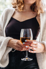 wine in a glass in the hands of a young girl