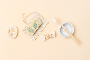 Zero waste bathroom accessories on cream color background. Natural eco bamboo product. Plastic free beauty essentials.