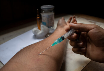 man injecting himself with a syringe