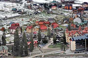 Fototapeta premium Typical landscape of the Ukrainian Carpathians with private estates in winter
