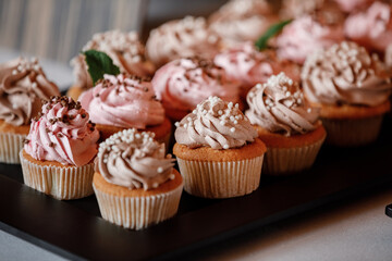 Cupcakes with curls of creamy strawberry glaze