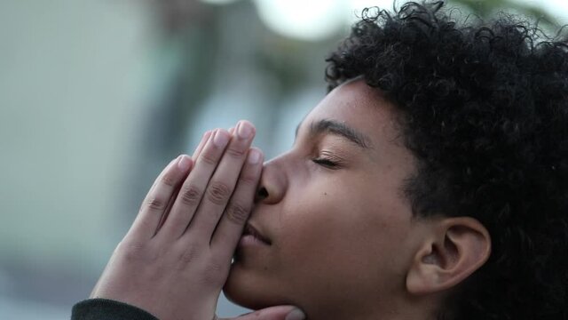 Religious young boy praying to GOD