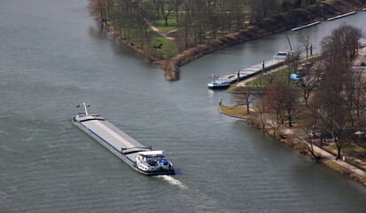 Inland bulk cargo ship passing an empty campsite in Bernkastel-Kues city on the Mosel river in...