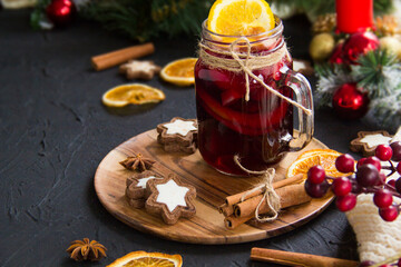 Christmas hot mulled wine with cinnamon cardamom and anise. Dark vintage dirty background. Creative atmospheric decoration